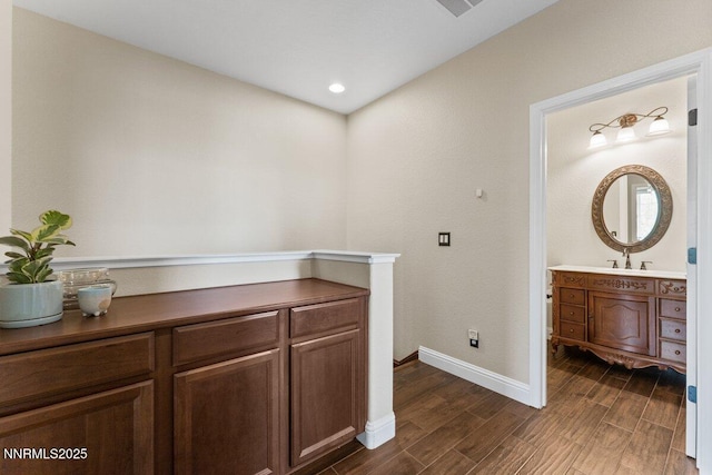 1955 Wind Ranch Rd Unit A, Reno, NV 89521 - hallway featuring baseboards, dark wood-style floors, and a sink