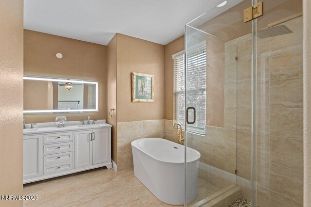 1955 Wind Ranch Rd Unit A, Reno, NV 89521 - full bath with double vanity, a shower stall, tile walls, a freestanding tub, and a wainscoted wall
