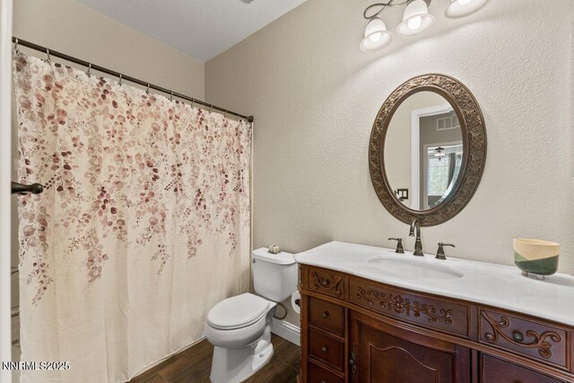 1955 Wind Ranch Rd Unit A, Reno, NV 89521 - bathroom with vanity, toilet, wood finished floors, and a shower with shower curtain
