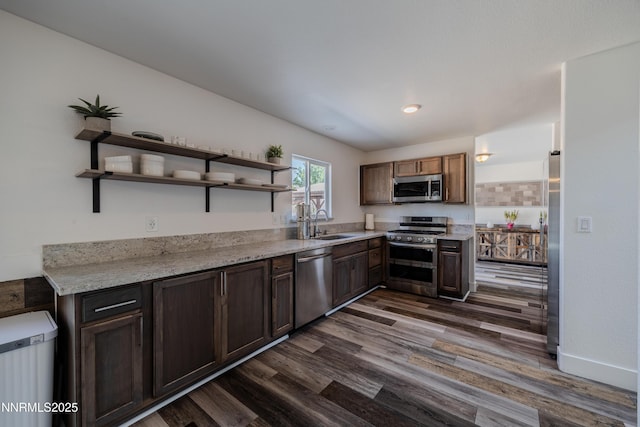 18105 Pasado Ct, Reno, NV 89508 - kitchen featuring appliances with stainless steel finishes, a sink, dark wood finished floors, open shelves, and light stone counters