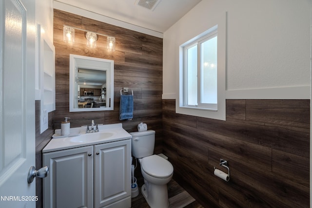 18105 Pasado Ct, Reno, NV 89508 - bathroom with toilet, vanity, and wooden walls