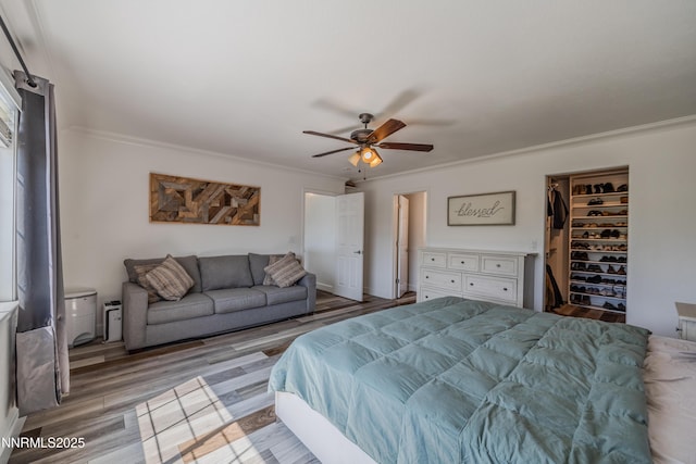 18105 Pasado Ct, Reno, NV 89508 - bedroom with crown molding, light wood-type flooring, a closet, a spacious closet, and a ceiling fan