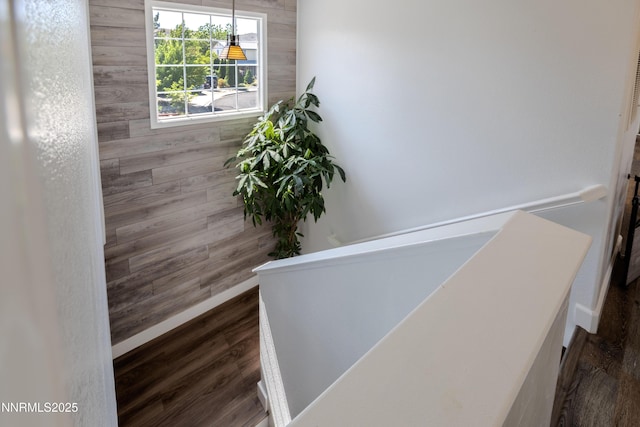 18105 Pasado Ct, Reno, NV 89508 - corridor with an upstairs landing, dark wood-style floors, baseboards, and wooden walls