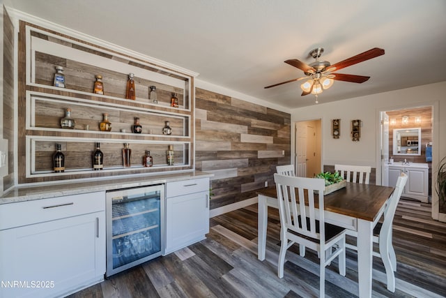 18105 Pasado Ct, Reno, NV 89508 - indoor dry bar featuring wine cooler, wood walls, ceiling fan, and dark wood finished floors