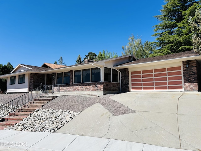 3411 San Juan Dr, Reno, NV 89509 - ranch-style house featuring a garage, brick siding, concrete driveway, and a porch