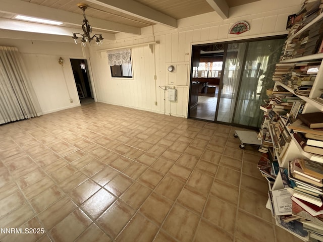 3411 San Juan Dr, Reno, NV 89509 - unfurnished room with beam ceiling, a chandelier, and wooden walls
