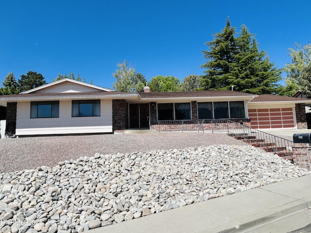 3411 San Juan Dr, Reno, NV 89509 - ranch-style house with brick siding, a garage, and concrete driveway