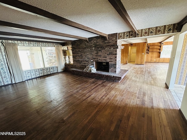 3411 San Juan Dr, Reno, NV 89509 - unfurnished living room featuring wood-type flooring, a textured ceiling, beam ceiling, a brick fireplace, and wooden walls