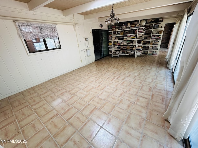 3411 San Juan Dr, Reno, NV 89509 - empty room featuring a chandelier, beamed ceiling, and wood walls