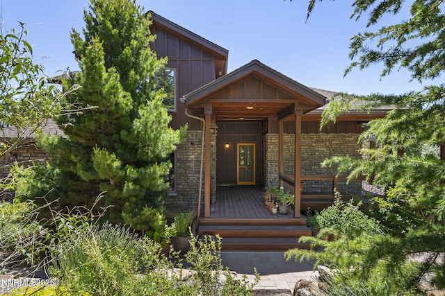 16460 Jefte Ct, Reno, NV 89511 - doorway to property with board and batten siding, stone siding, and covered porch
