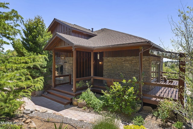 16460 Jefte Ct, Reno, NV 89511 - view of front of house featuring board and batten siding, roof with shingles, stone siding, and a deck