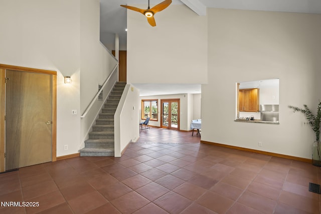 16460 Jefte Ct, Reno, NV 89511 - unfurnished living room with high vaulted ceiling, ceiling fan, stairs, tile patterned flooring, and beam ceiling