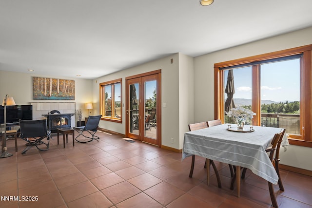 16460 Jefte Ct, Reno, NV 89511 - dining room featuring tile patterned floors, a mountain view, recessed lighting, and a fireplace