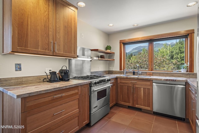 16460 Jefte Ct, Reno, NV 89511 - kitchen featuring appliances with stainless steel finishes, tile patterned floors, brown cabinets, open shelves, and recessed lighting