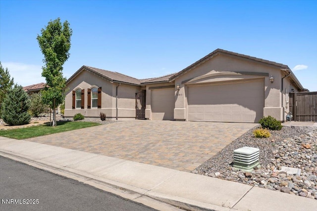 1080 S University Park Loop, Reno, NV 89512 - single story home featuring stucco siding, a garage, and decorative driveway