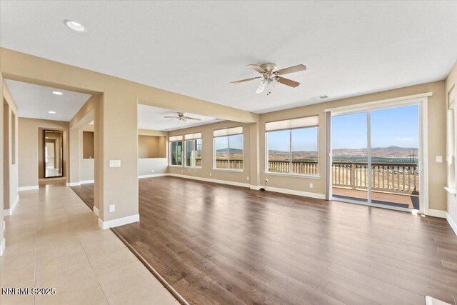 1080 S University Park Loop, Reno, NV 89512 - unfurnished living room with ceiling fan, baseboards, wood finished floors, and recessed lighting