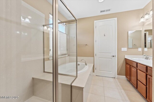 1080 S University Park Loop, Reno, NV 89512 - bathroom with vanity, a bath, a shower stall, tile patterned floors, and baseboards