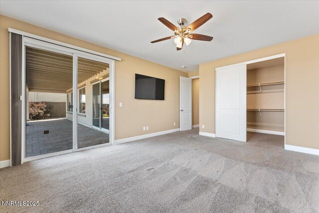 1080 S University Park Loop, Reno, NV 89512 - unfurnished bedroom featuring access to outside, carpet flooring, baseboards, a ceiling fan, and a spacious closet