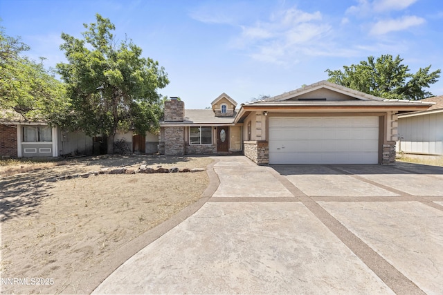 779 E York Way, Sparks, NV 89434 - single story home featuring concrete driveway, an attached garage, stone siding, and a chimney