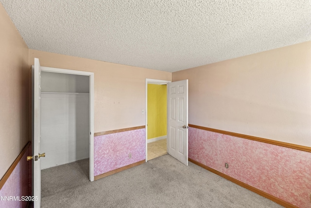 779 E York Way, Sparks, NV 89434 - unfurnished bedroom featuring a textured ceiling, a closet, and carpet flooring