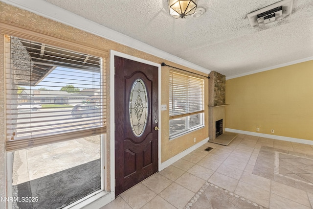779 E York Way, Sparks, NV 89434 - foyer featuring ornamental molding, baseboards, a fireplace, a textured ceiling, and light tile patterned flooring