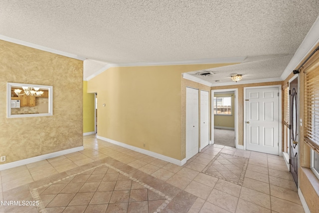 779 E York Way, Sparks, NV 89434 - empty room featuring baseboards, inlaid floor details, ornamental molding, light tile patterned floors, and a textured ceiling