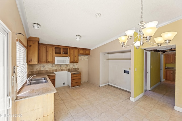 779 E York Way, Sparks, NV 89434 - kitchen with a sink, ornamental molding, white microwave, decorative backsplash, and vaulted ceiling