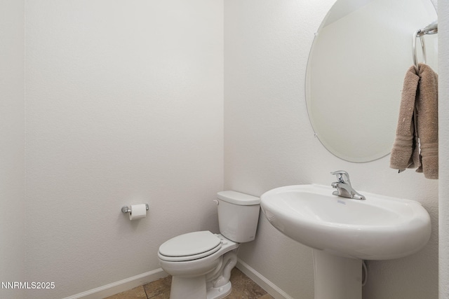 3002 Sterling Ridge Cir, Sparks, NV 89431 - half bathroom with toilet, baseboards, tile patterned floors, and a sink