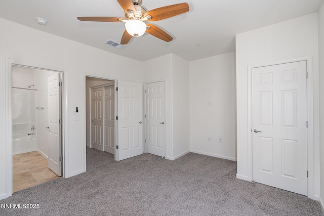 3002 Sterling Ridge Cir, Sparks, NV 89431 - unfurnished bedroom featuring carpet floors, ensuite bathroom, baseboards, two closets, and ceiling fan