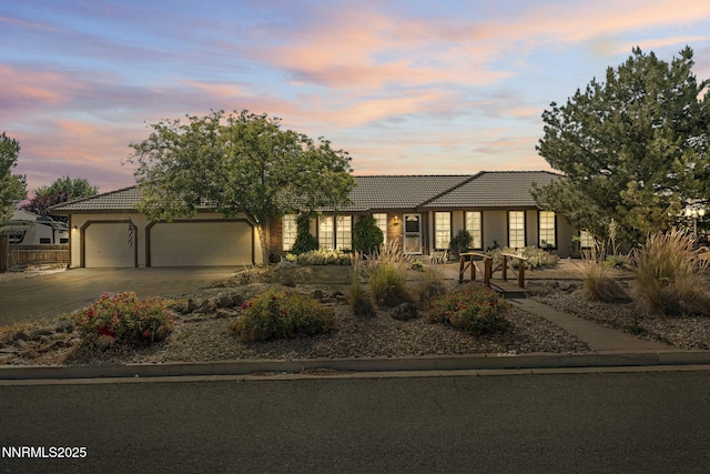 115 Stags Leap Cir, Spanish Springs, NV 89441 - view of front facade with a tiled roof, a garage, driveway, and stucco siding