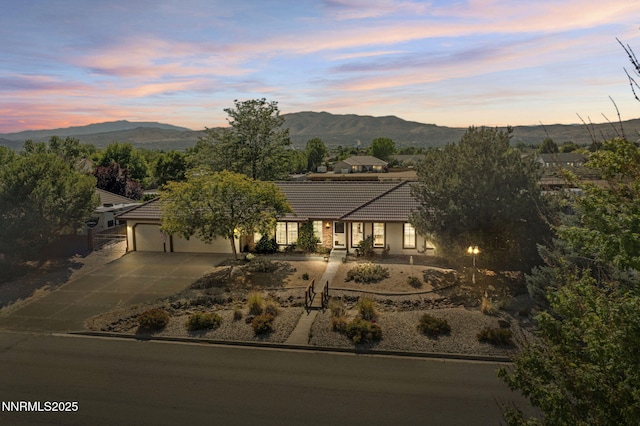 115 Stags Leap Cir, Spanish Springs, NV 89441 - view of front of home featuring a tile roof, a garage, and a mountain view