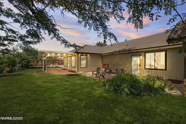 115 Stags Leap Cir, Spanish Springs, NV 89441 - back of property at dusk featuring a patio and a tile roof