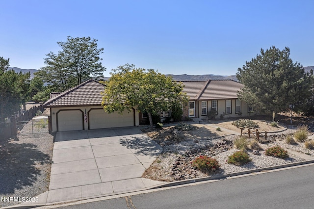 115 Stags Leap Cir, Spanish Springs, NV 89441 - view of front of home featuring a tiled roof, a garage, driveway, and a mountain view