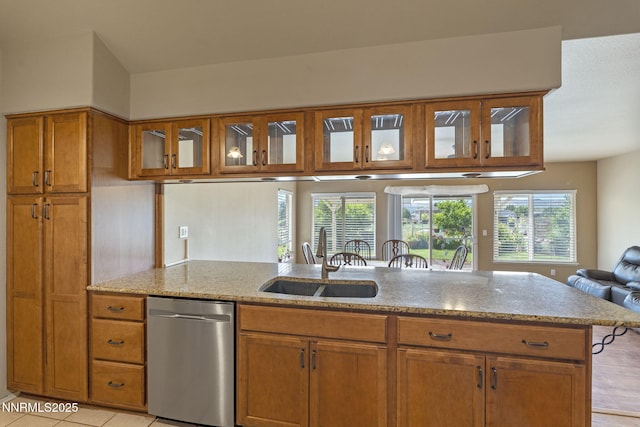 115 Stags Leap Cir, Spanish Springs, NV 89441 - kitchen featuring dishwasher, brown cabinets, light stone counters, and open floor plan
