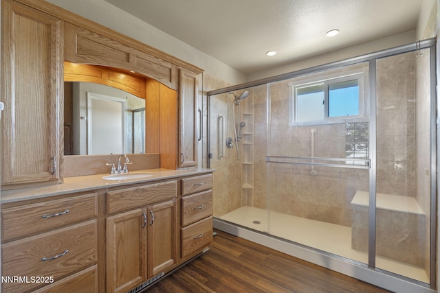 115 Stags Leap Cir, Spanish Springs, NV 89441 - full bath with vanity, a shower stall, wood finished floors, and recessed lighting