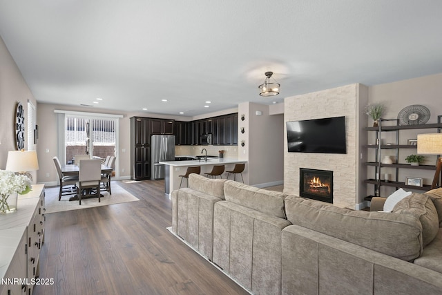 2064 Whitecliff Dr, Reno, NV 89521 - living room with dark wood-type flooring, a fireplace, baseboards, and recessed lighting