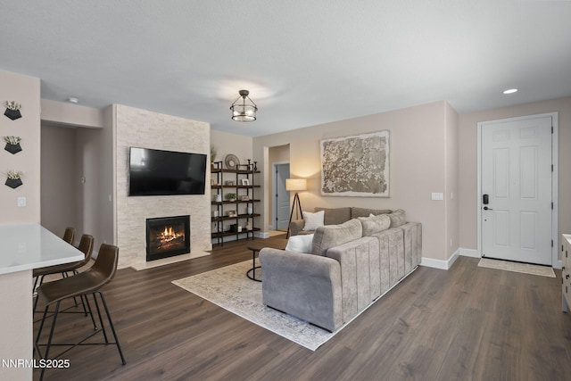 2064 Whitecliff Dr, Reno, NV 89521 - living room featuring dark wood-type flooring, baseboards, a stone fireplace, and recessed lighting