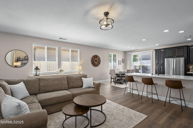 2064 Whitecliff Dr, Reno, NV 89521 - living area with dark wood-style flooring, recessed lighting, baseboards, and a textured ceiling
