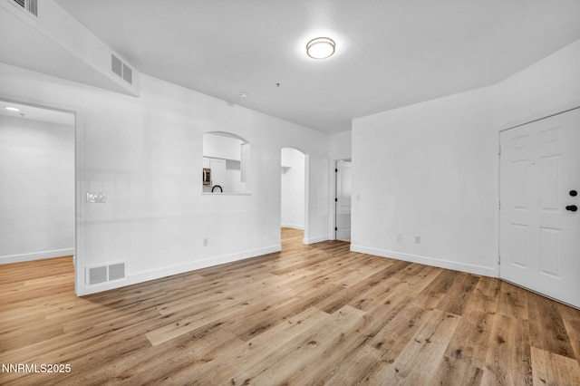 6850 Sharlands Ave # E1017, Reno, NV 89523 - spare room featuring wood finished floors and arched walkways