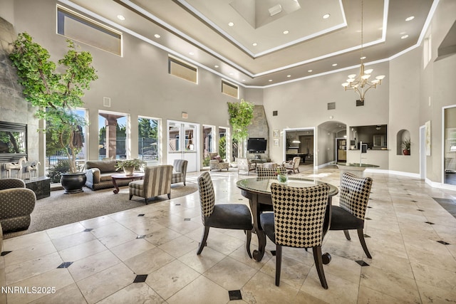 6850 Sharlands Ave # E1017, Reno, NV 89523 - tiled dining room featuring a high ceiling, recessed lighting, a chandelier, arched walkways, and ornamental molding