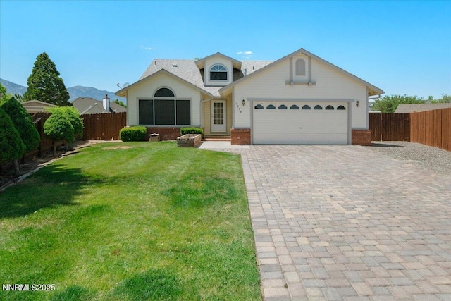 1290 Saddlehorn Ct, Minden, NV 89423 - view of front of house featuring brick siding, decorative driveway, and an attached garage