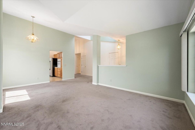 1290 Saddlehorn Ct, Minden, NV 89423 - unfurnished living room featuring light carpet and high vaulted ceiling