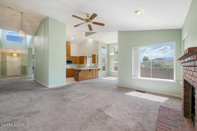 1290 Saddlehorn Ct, Minden, NV 89423 - unfurnished living room with a brick fireplace, light carpet, high vaulted ceiling, and a ceiling fan