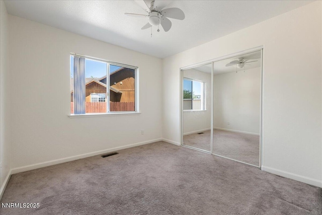 1290 Saddlehorn Ct, Minden, NV 89423 - unfurnished bedroom with multiple windows, carpet flooring, a closet, and a ceiling fan