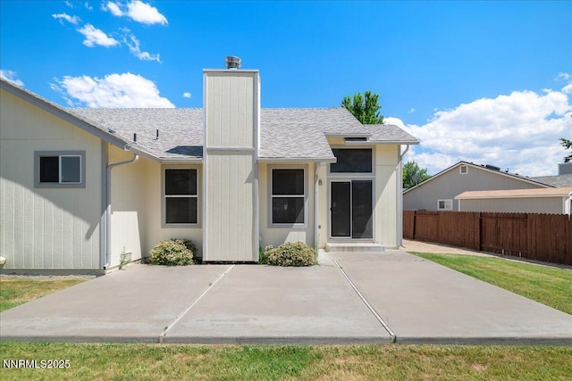 1290 Saddlehorn Ct, Minden, NV 89423 - rear view of house with a patio area, a chimney, and roof with shingles