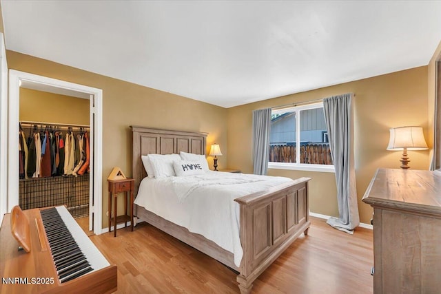 809 Glen Valley Dr, Sparks, NV 89434 - bedroom featuring light wood-style floors, a walk in closet, baseboards, and a closet