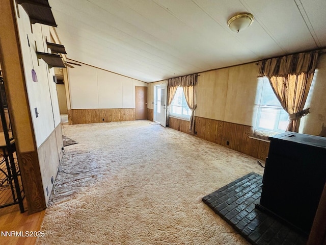 6480 Teal Dr, Fallon, NV 89406 - carpeted empty room featuring wood walls, a wainscoted wall, and vaulted ceiling