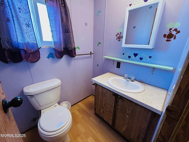 6480 Teal Dr, Fallon, NV 89406 - half bath featuring vanity, wood finished floors, and toilet
