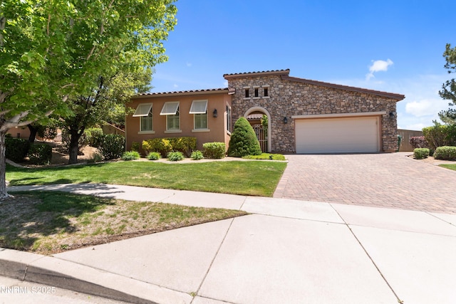 7601 Autumn Ridge Cir, Reno, NV 89523 - mediterranean / spanish-style house with decorative driveway, stone siding, a garage, a front lawn, and stucco siding