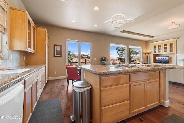 7601 Autumn Ridge Cir, Reno, NV 89523 - kitchen featuring dishwasher, recessed lighting, dark wood-style flooring, a center island, and light stone countertops